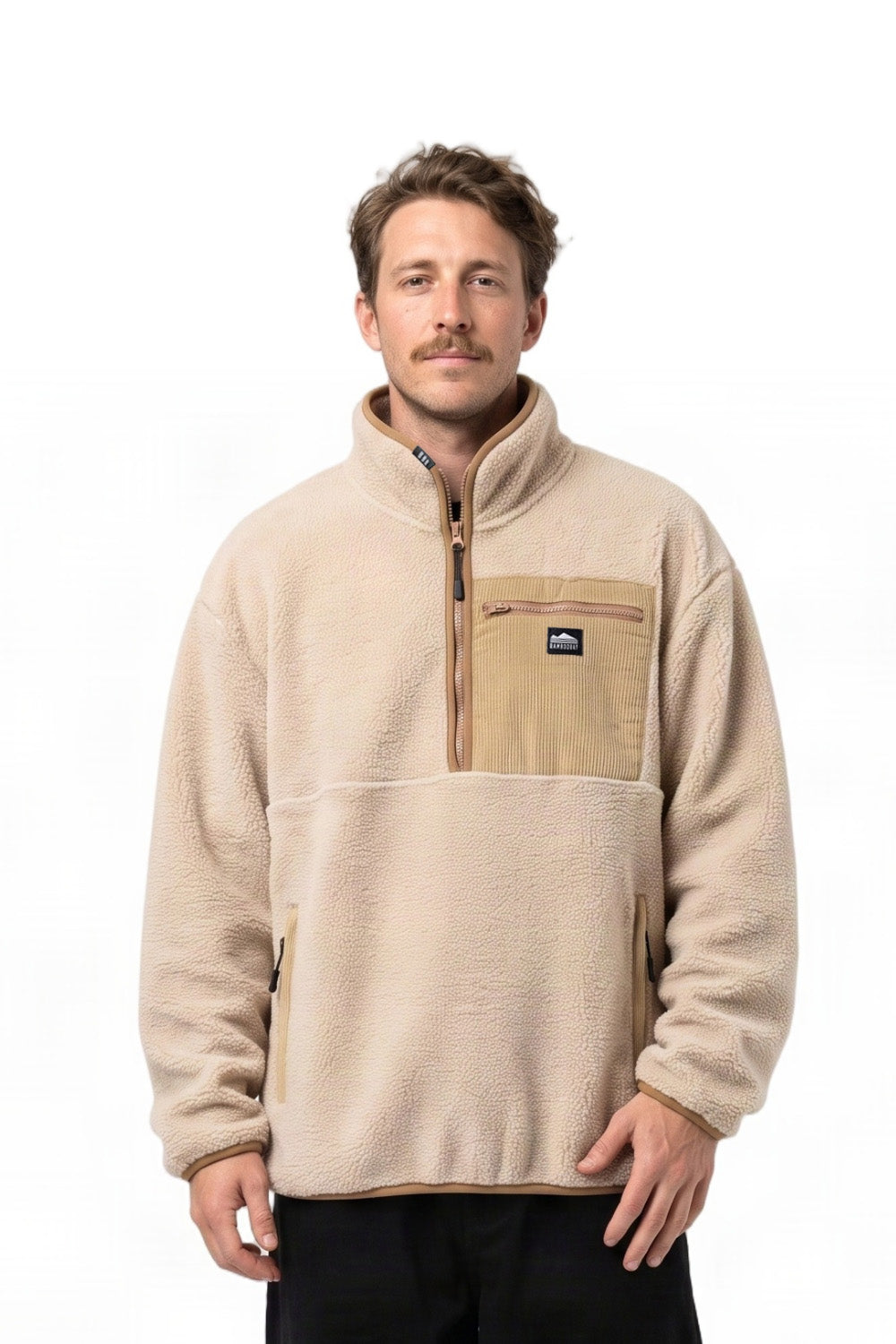 A man wearing a beige and tan quarter-zip fleece pullover jacket with a stand-up collar, photographed against a plain white background.