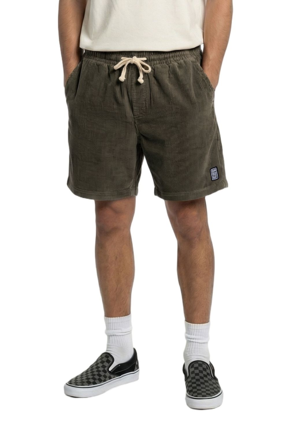 Person wearing green shorts with a brand logo on a white background