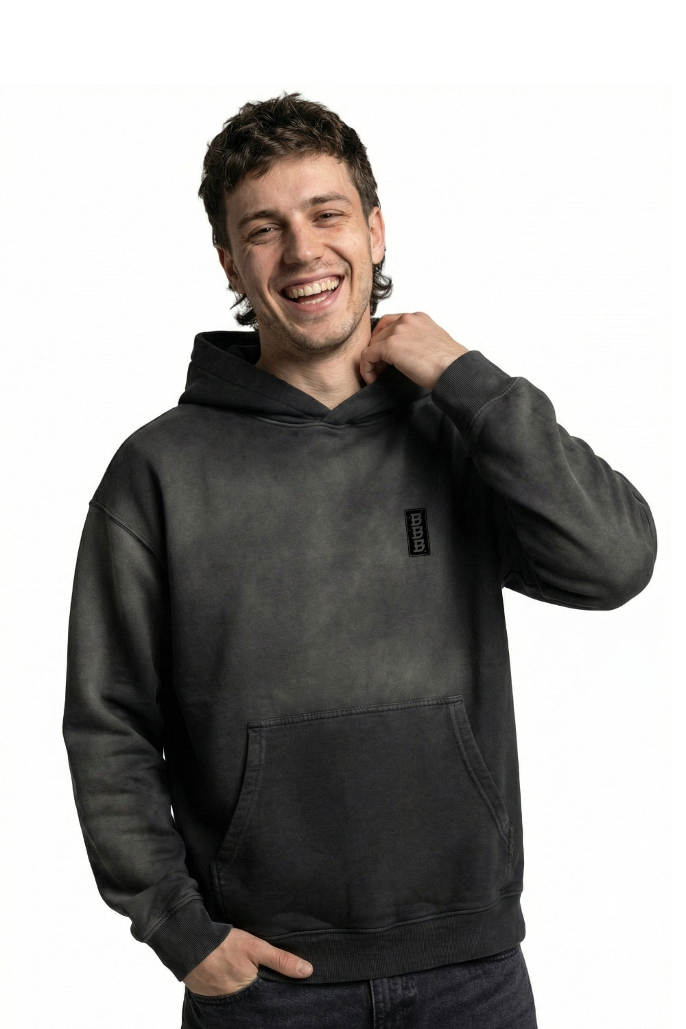 Man wearing a black hoodie with a small logo on a white background