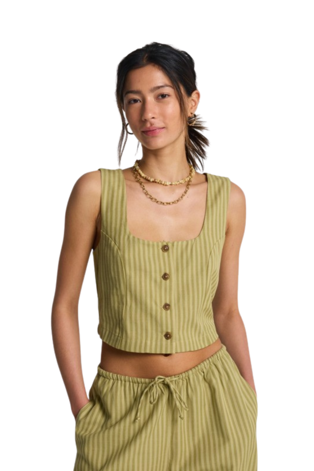 Woman wearing a green ribbed tank top with buttons and matching pants on a white background