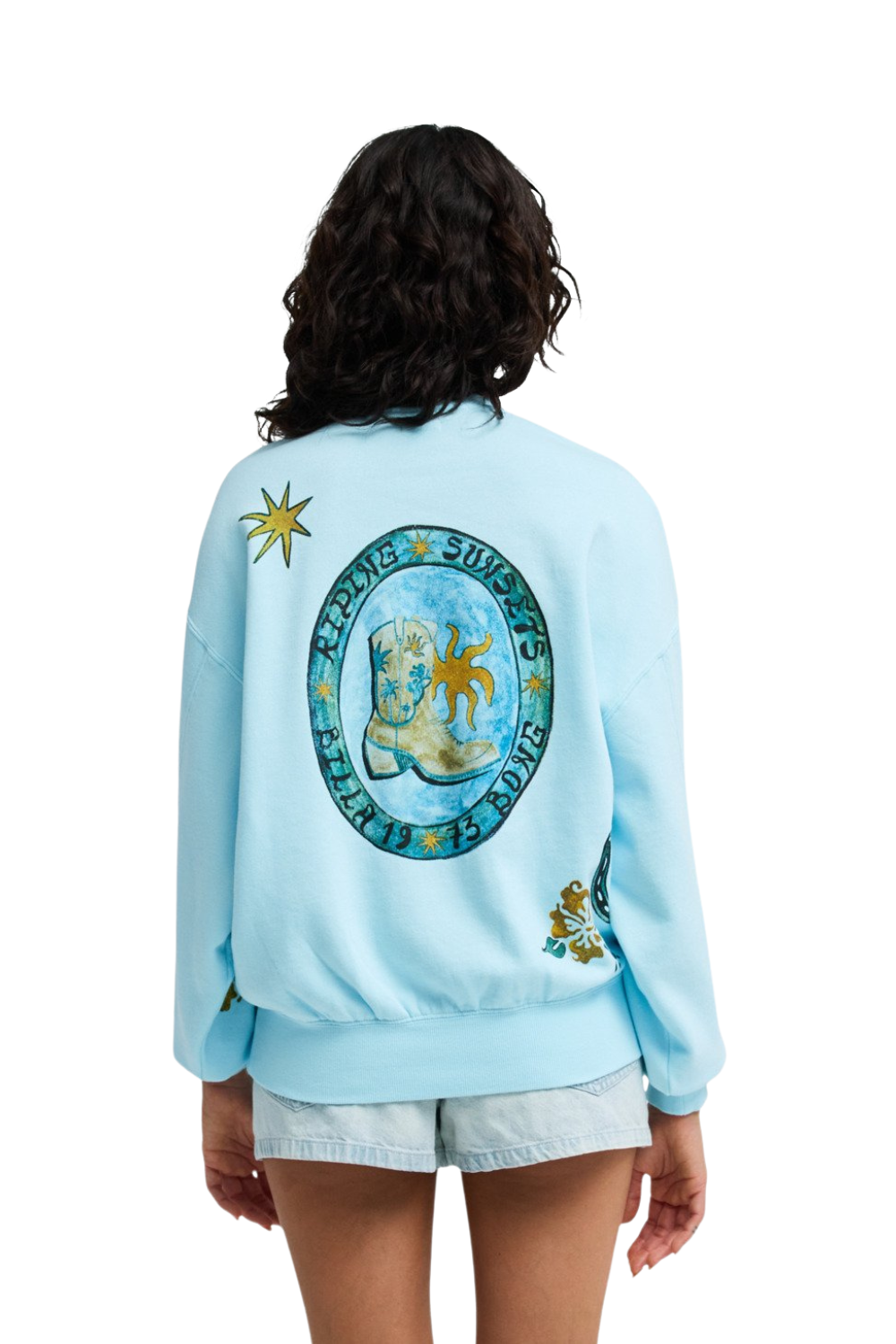 Light blue sweatshirt with a graphic design on the back, worn by a person.