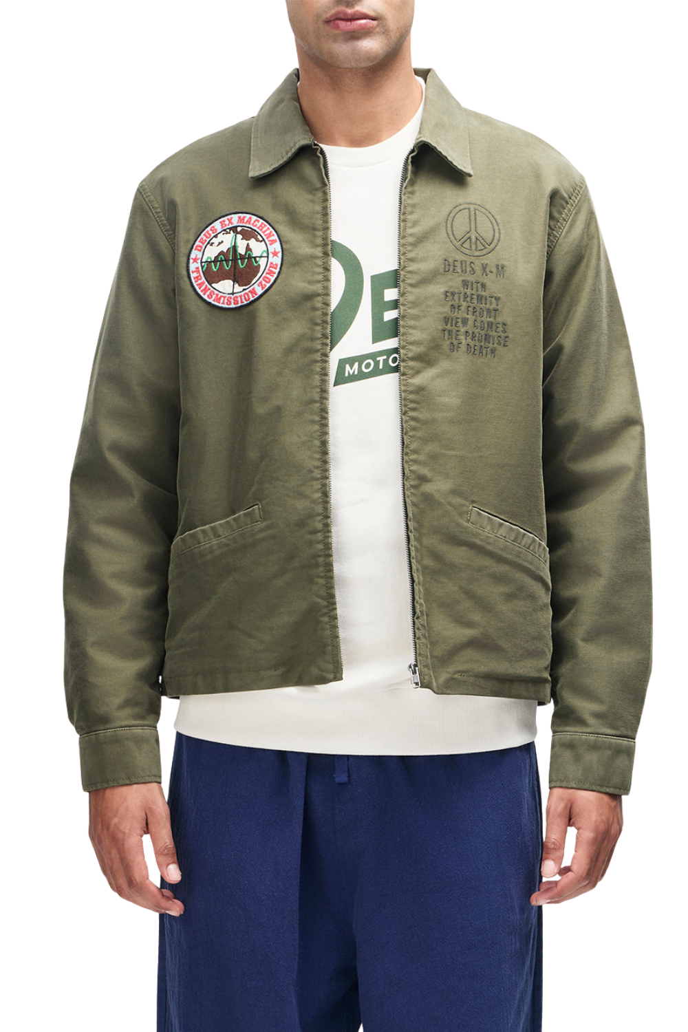 Green jacket with patches worn by a person on a white background