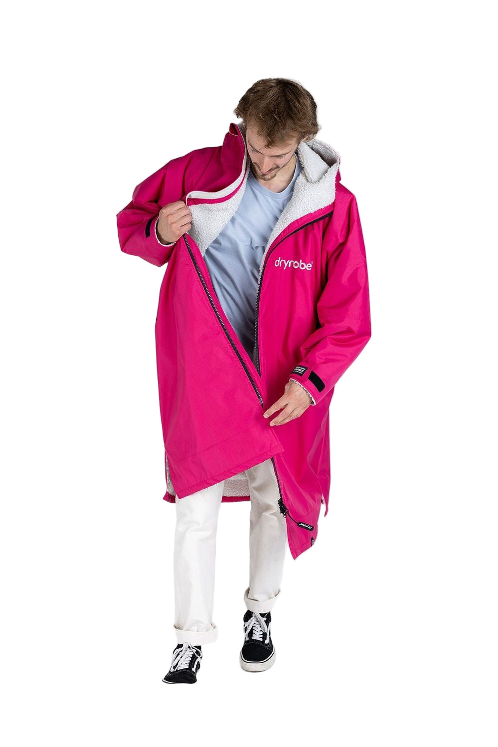 Adult wearing a long sleeve pink and light grey dryrobe with a hood.