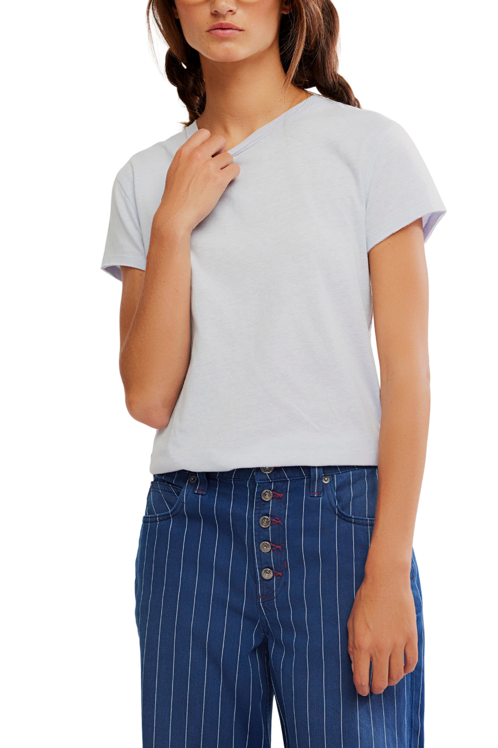 Woman wearing a light gray t-shirt and blue pinstripe pants on a white background