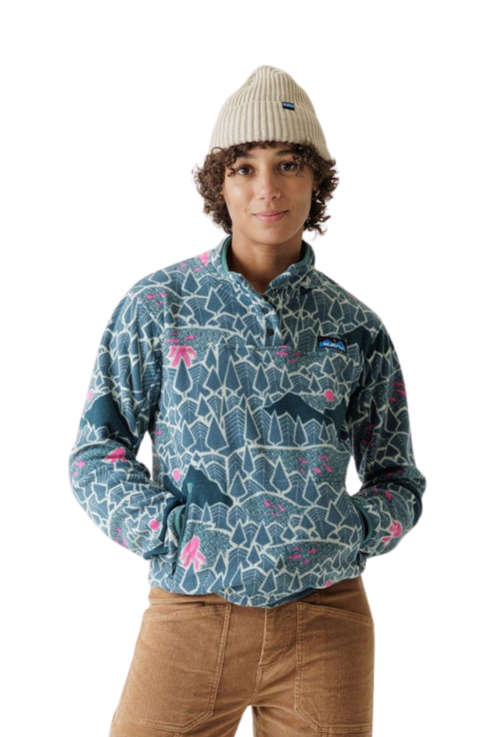 A model wearing a Kavu snap pullover fleece in a blue-gray colour with a pink and white abstract pattern, paired with a beige knit beanie and brown corduroy pants, against a solid white background.