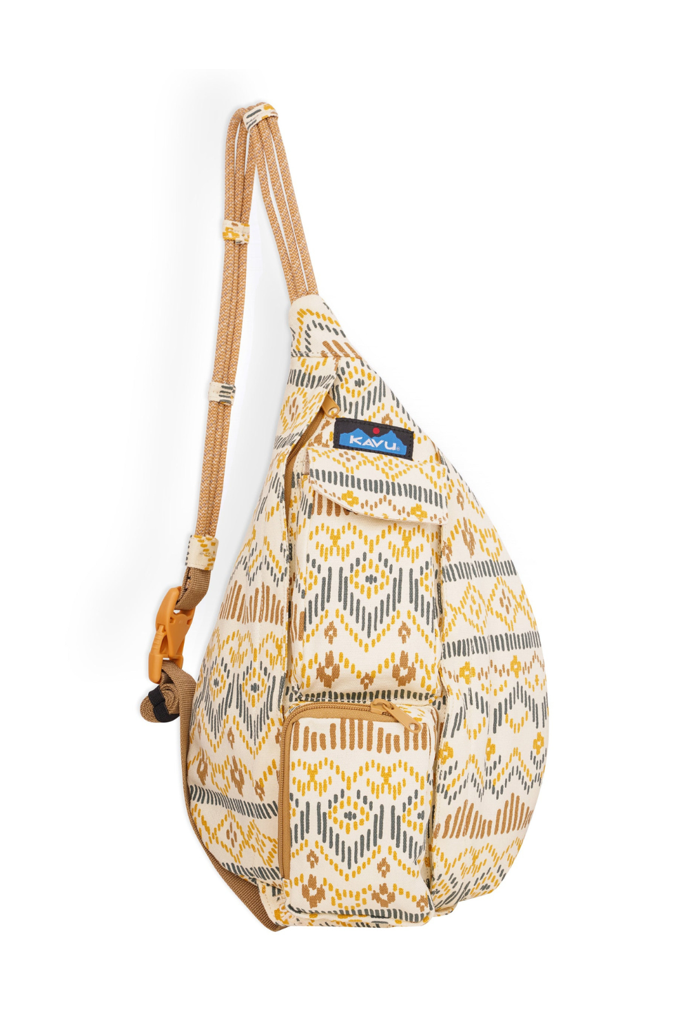A Kavu shoulder bag with a beige, yellow, and grey geometric pattern, featuring a wide adjustable shoulder strap and a blue Kavu logo patch on the front.