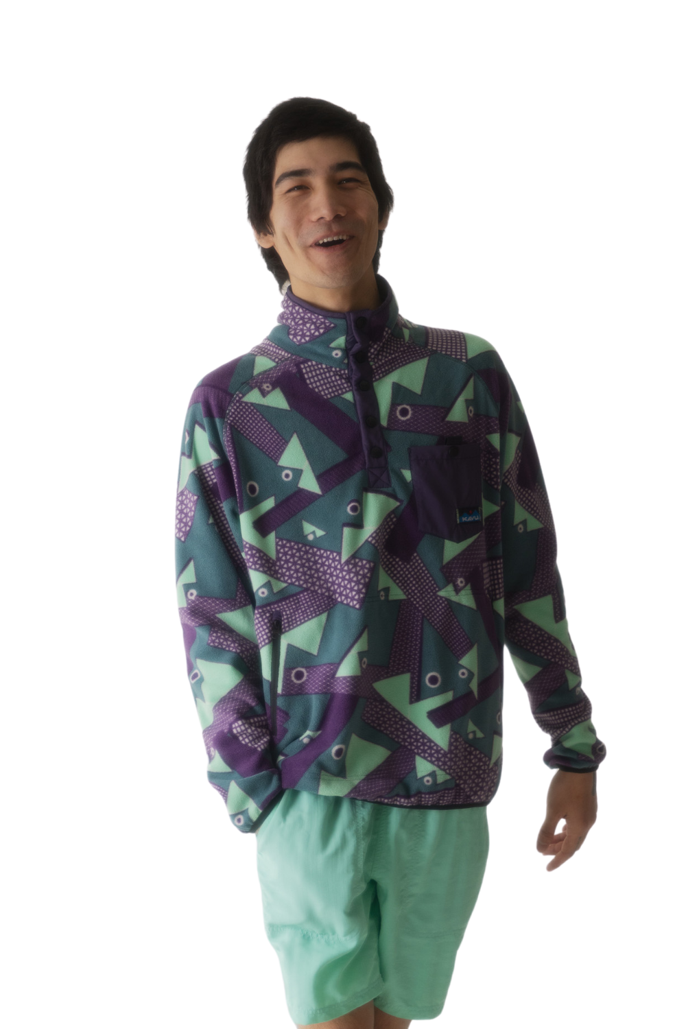 Person wearing a colorful patterned fleece pullover on a white background