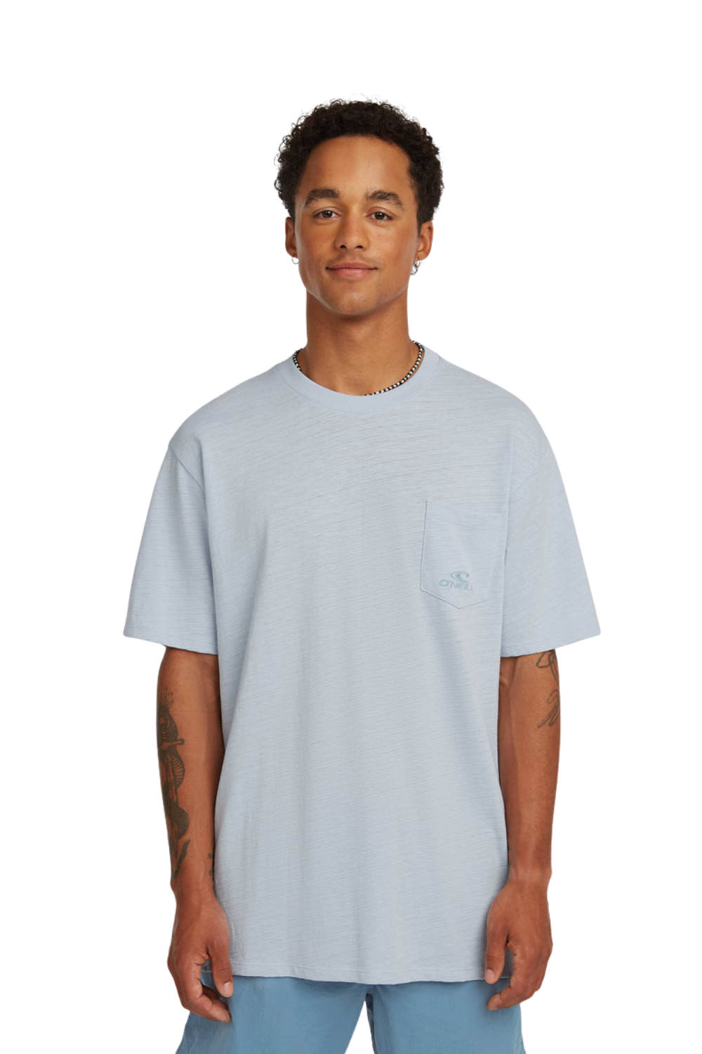 Person wearing a light blue T-shirt with chest pocket and small logo