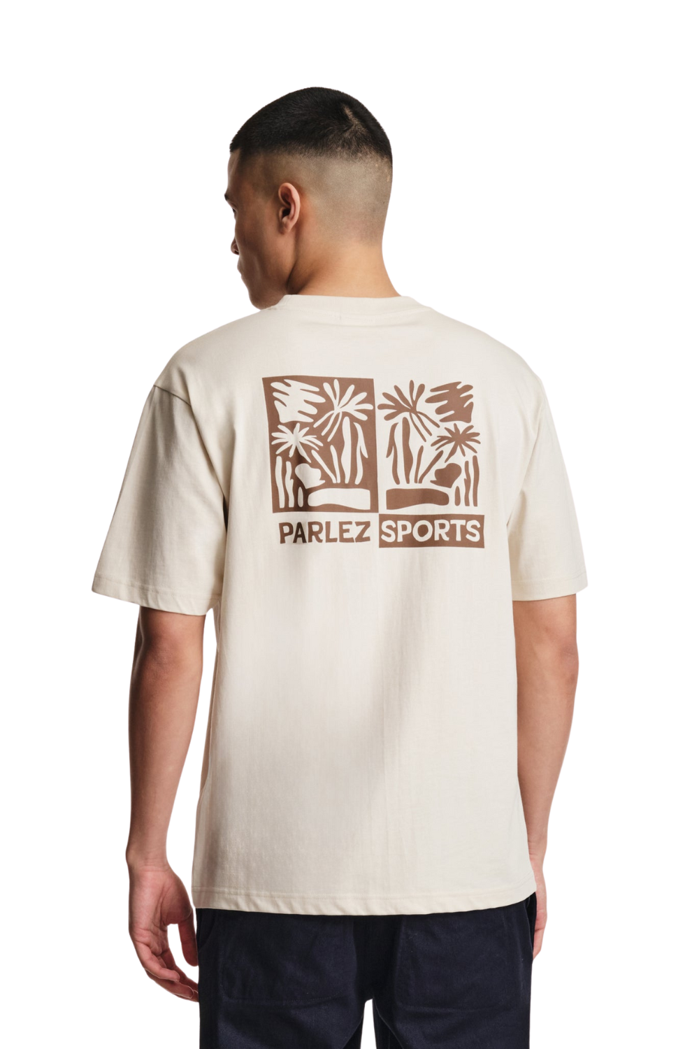 Man wearing a beige t-shirt with a logo and text on a white background