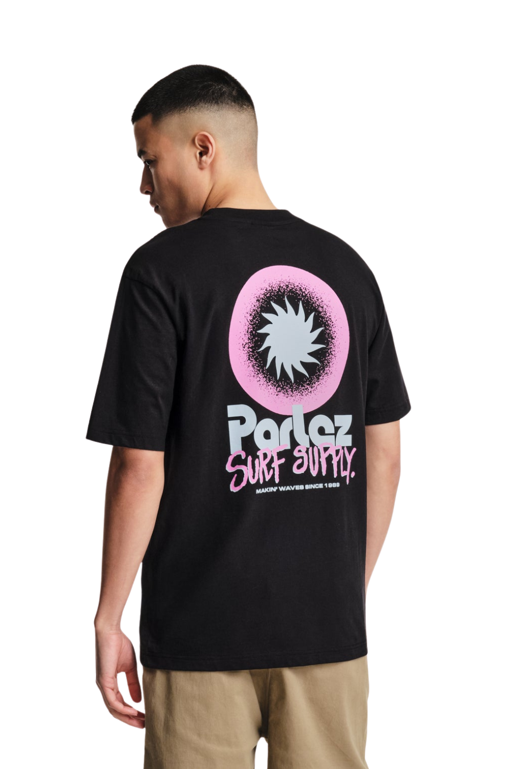 Person wearing a black t-shirt with a colorful graphic on the back, standing against a white background