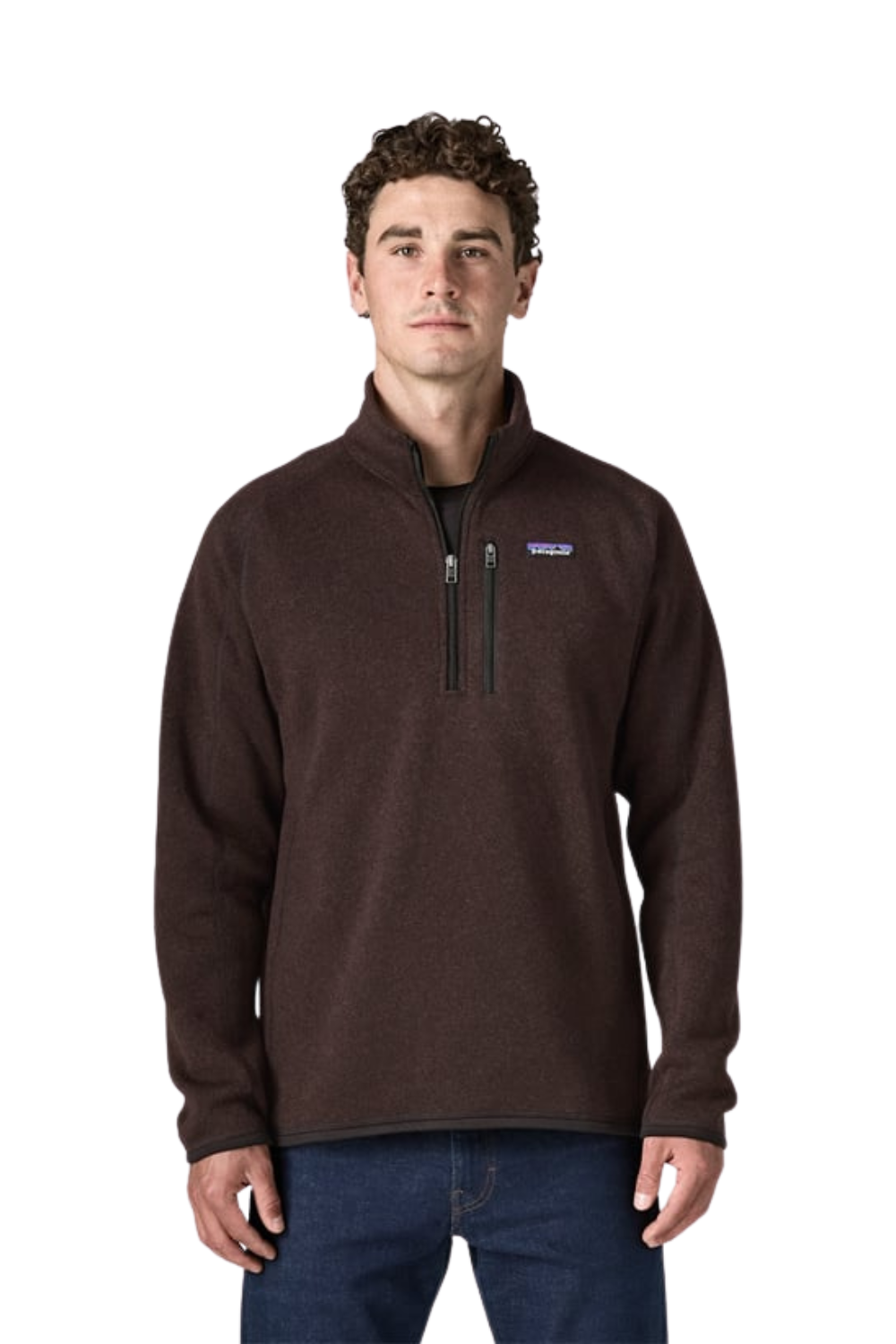 A man wearing a dark brown quarter-zip fleece pullover with a zippered chest pocket and a small Patagonia logo on the left chest, paired with blue jeans, against a plain white background.