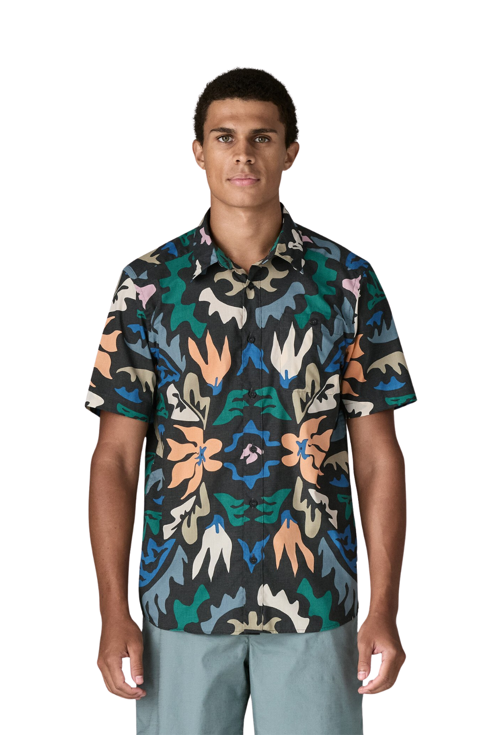 Man wearing a colorful patterned shirt on a white background