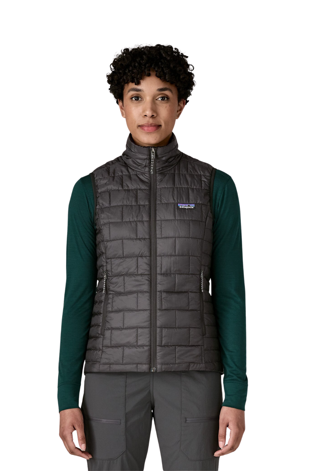 Person wearing a gray quilted vest with Patagonia logo on a white background