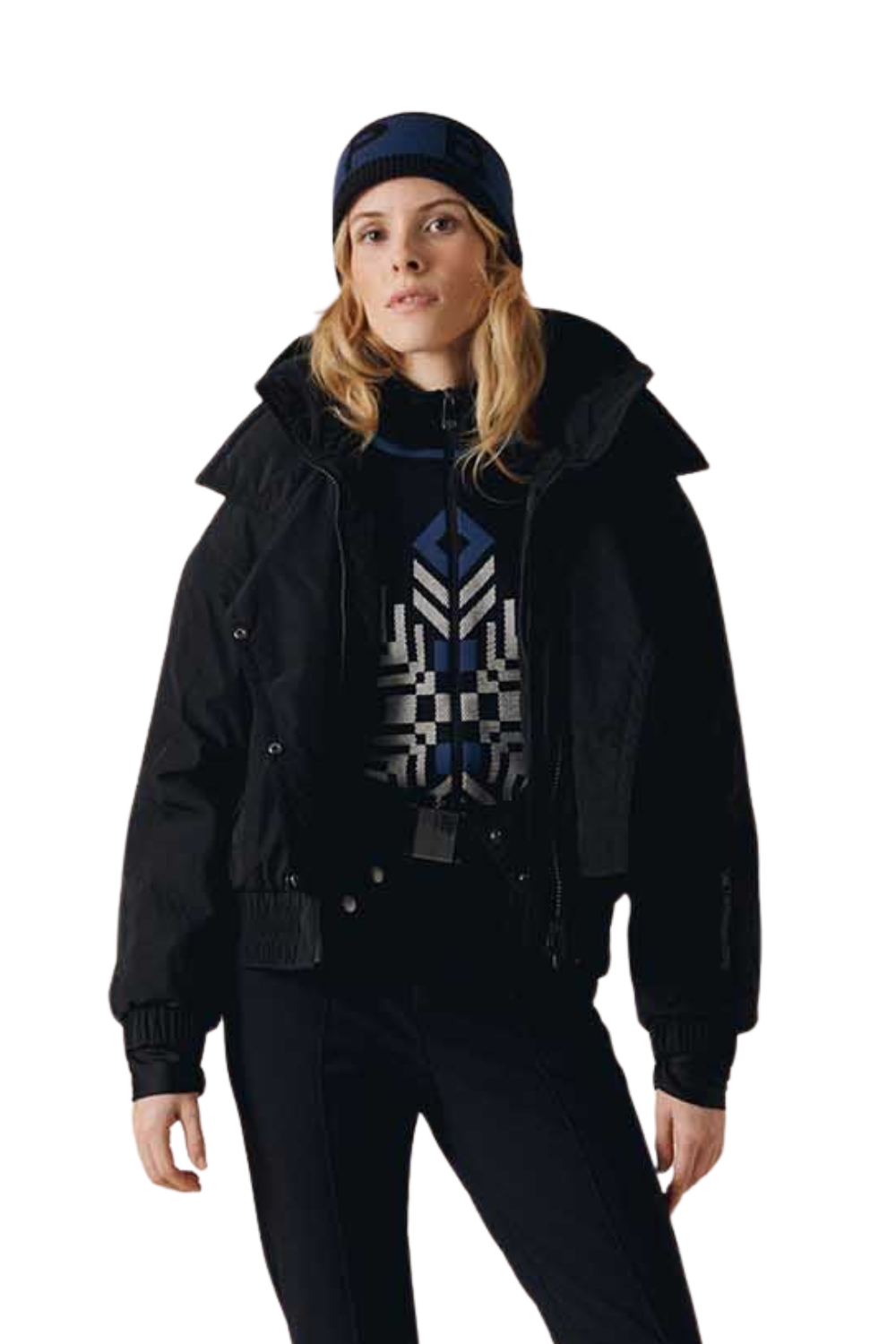 Person wearing a black jacket, blue beanie, and patterned sweater on a white background