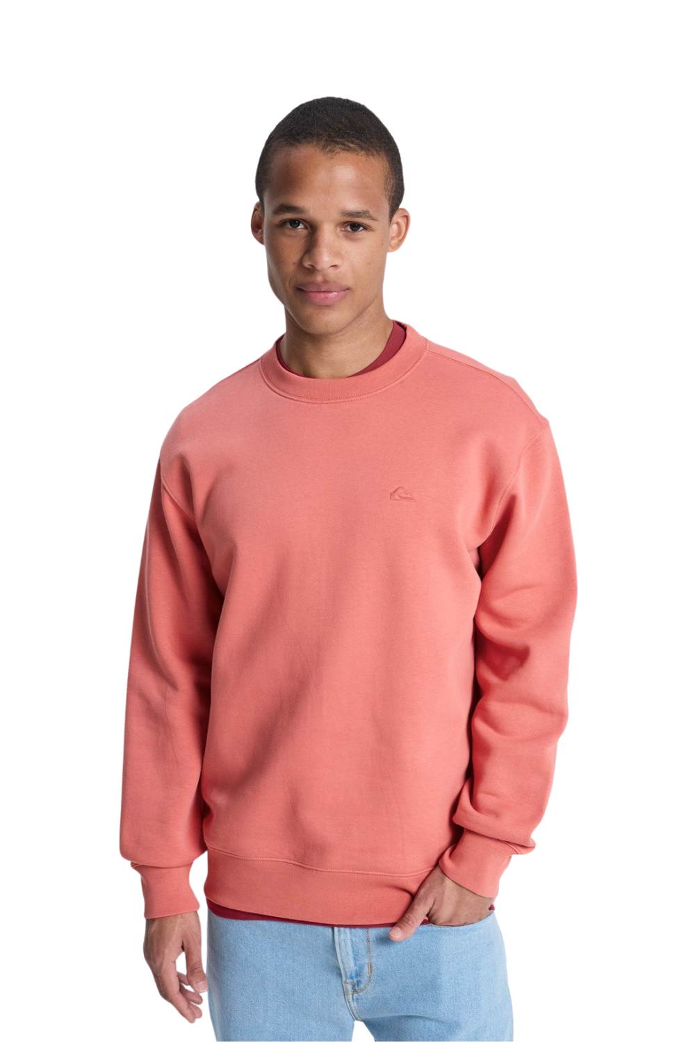 Man wearing a coral sweatshirt with a small logo on a white background