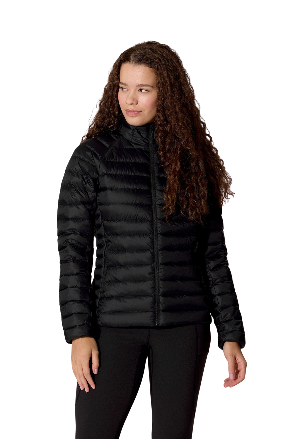 A woman with long, curly brown hair wearing a black 'Rab' puffer jacket and black pants, standing against a solid white background.