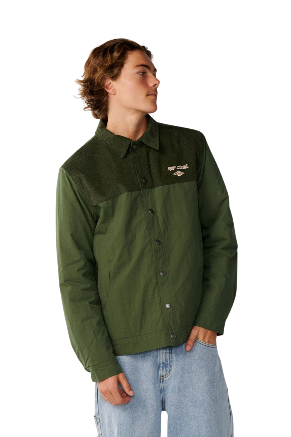 A man wearing an olive green color-blocked button-up jacket with a small embroidered logo on the left chest, paired with light blue jeans, against a plain white background.