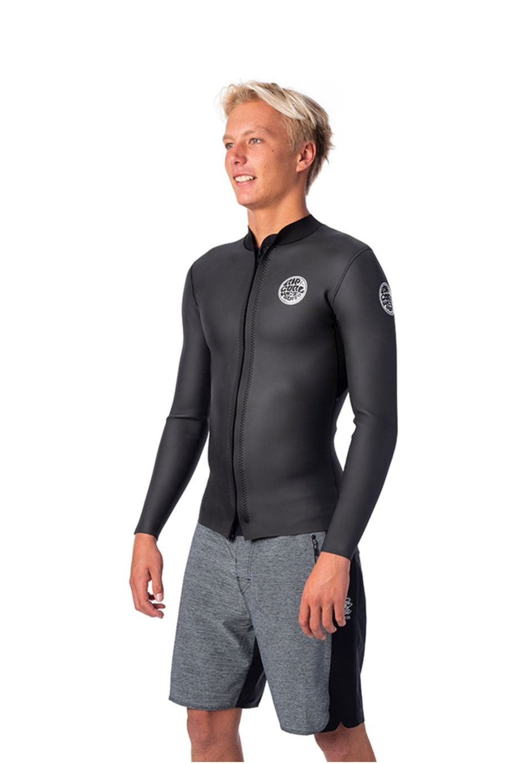 A man wearing a black long-sleeve wetsuit top with a full zipper and gray shorts, standing against a plain white background.