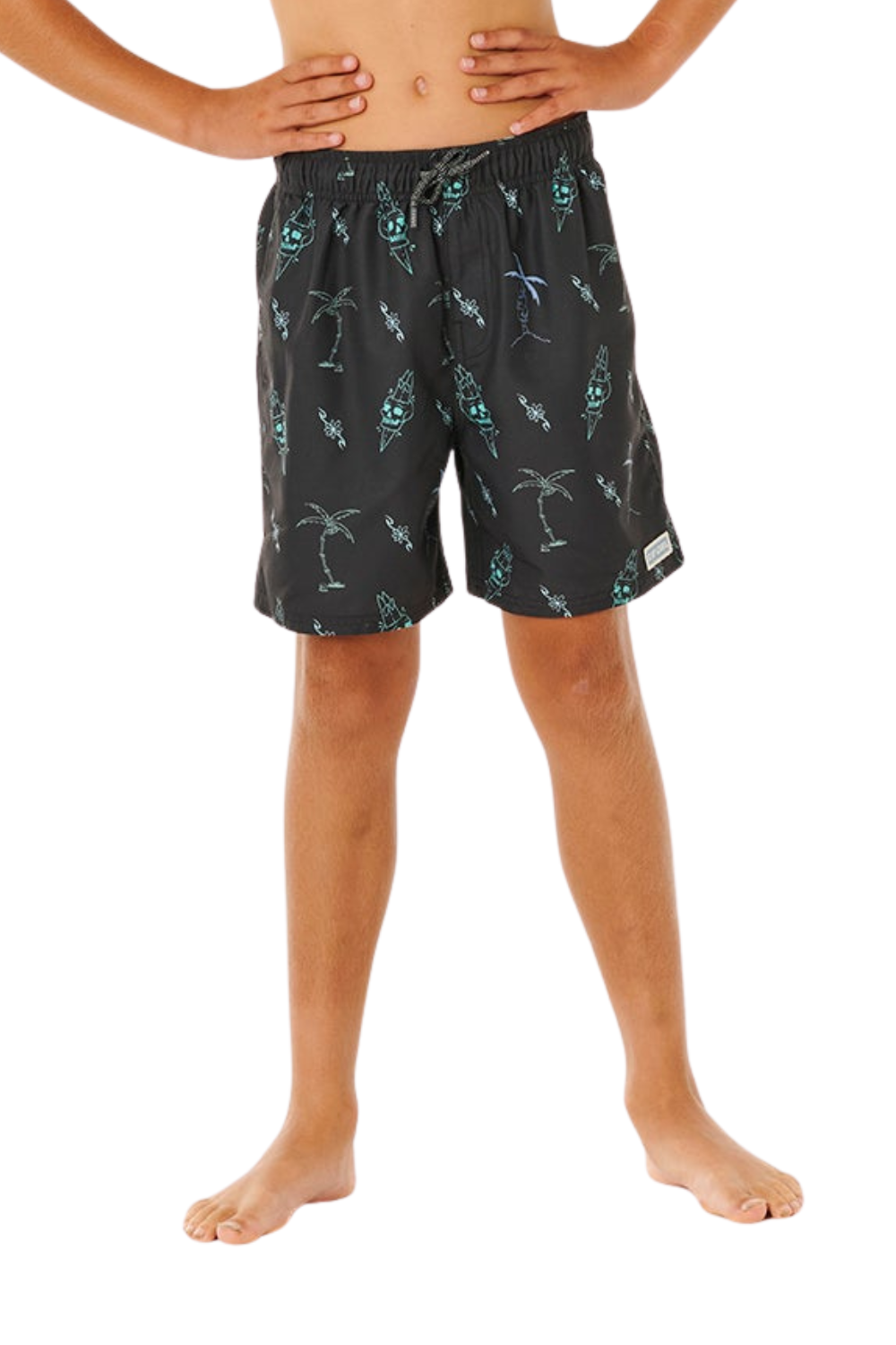 Person wearing black swim shorts with a pattern on a white background