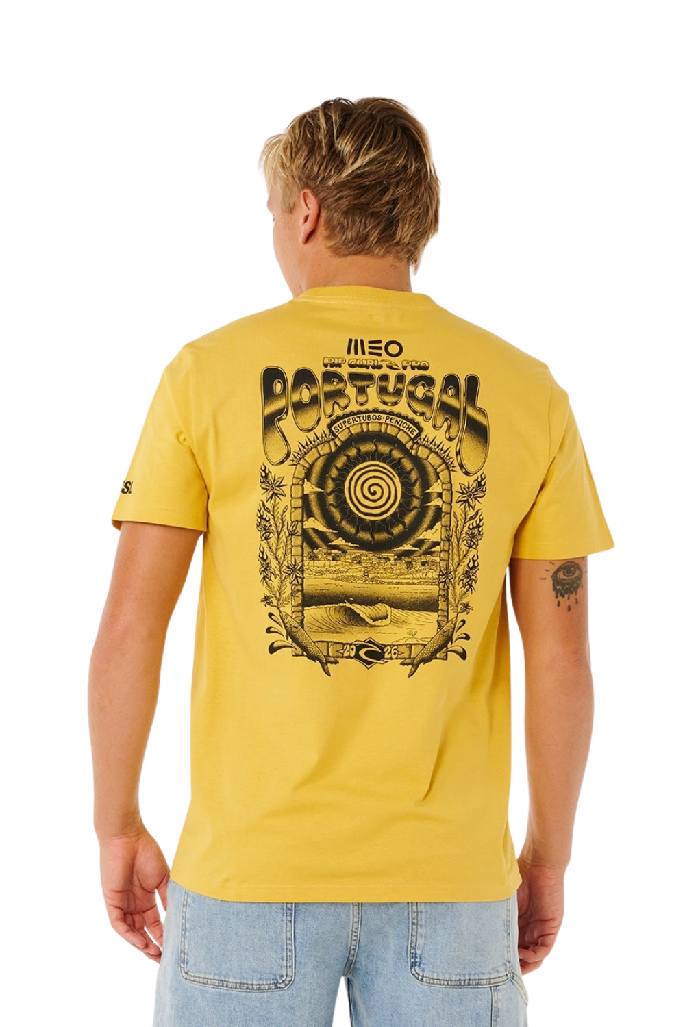 A man viewed from behind wearing a yellow t-shirt with a large black graphic print on the back featuring the word 'MEO RIP CURL PORTUGAL' and a spiral design, paired with light blue jeans against a white background.