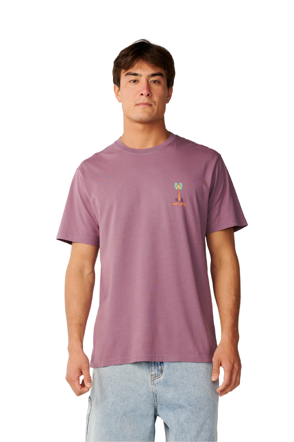 A man wearing a mauve-purple short-sleeve t-shirt with a small green and orange palm tree graphic on the left chest, paired with light blue jeans, against a plain white background.