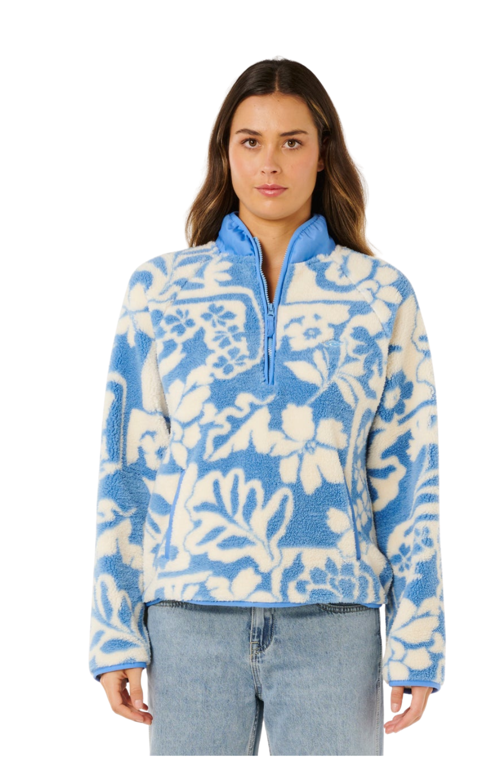 Woman wearing a blue and white floral patterned pullover on a white background
