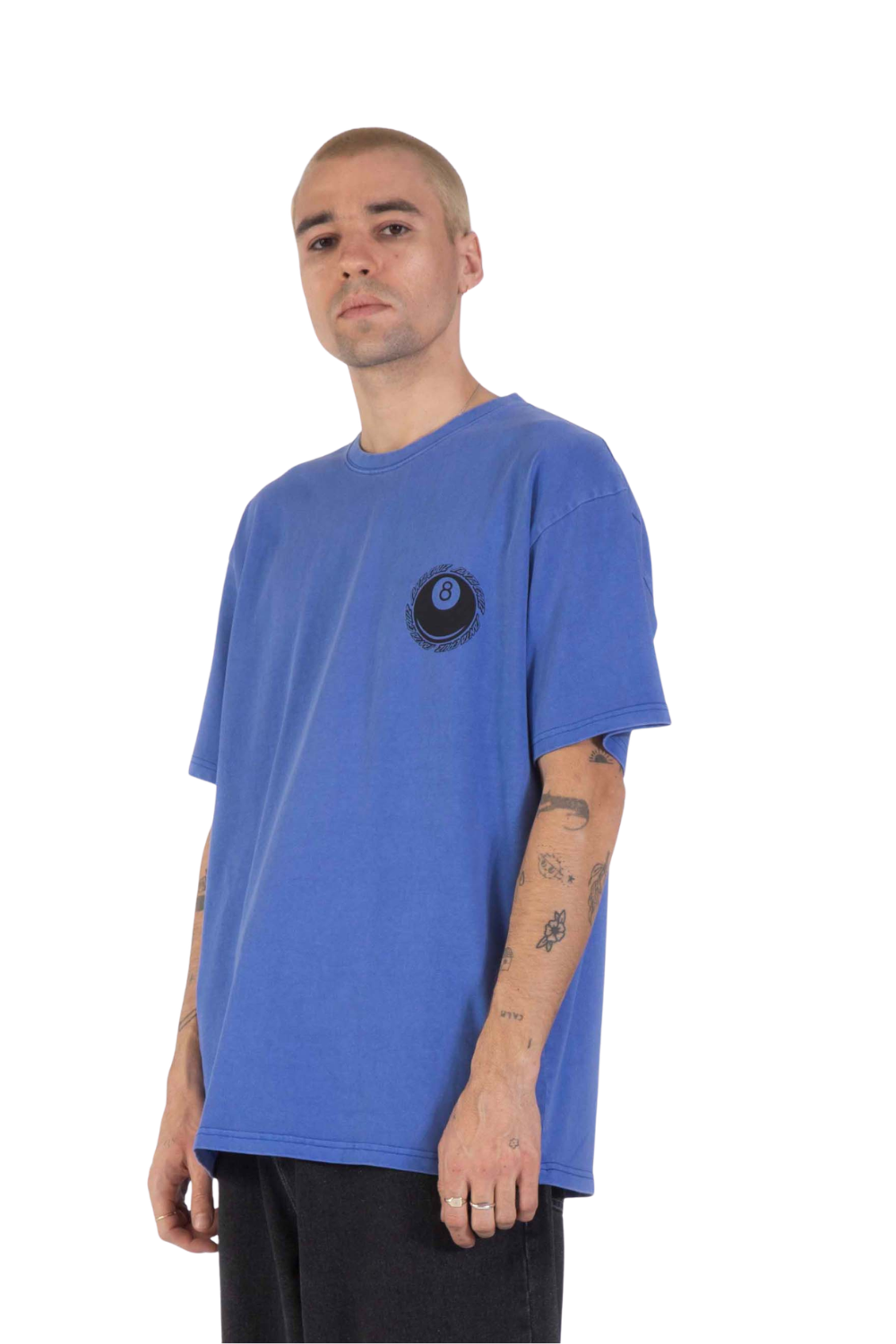 Man wearing a bright blue t-shirt with a graphic print of a hachi ball and santa cruz logo on the chest.