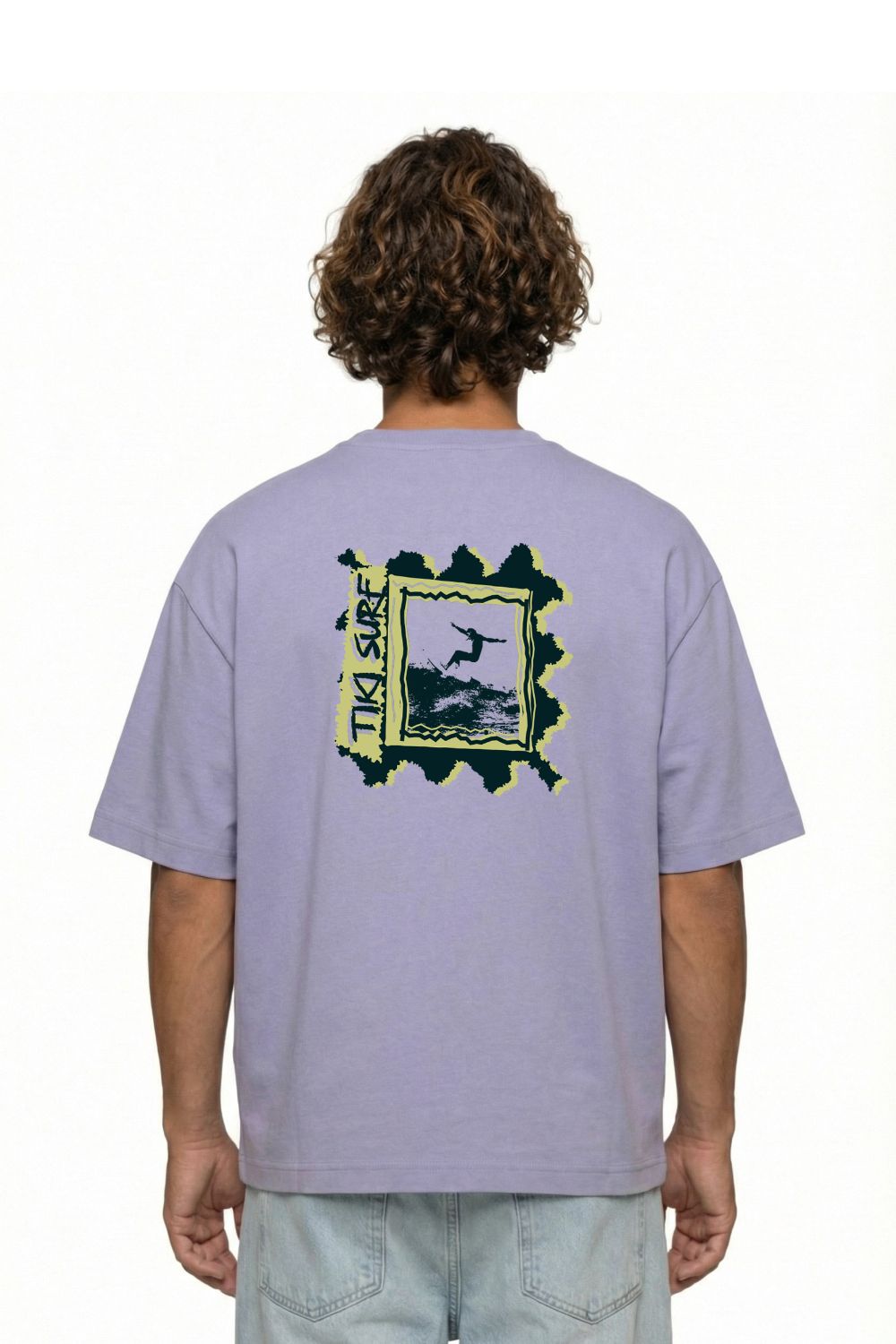 Person wearing a light purple t-shirt with a graphic design on the back, standing against a white background.