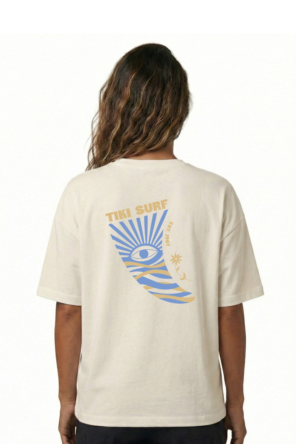 Person wearing a beige t-shirt with a colorful graphic on the back, standing against a white background