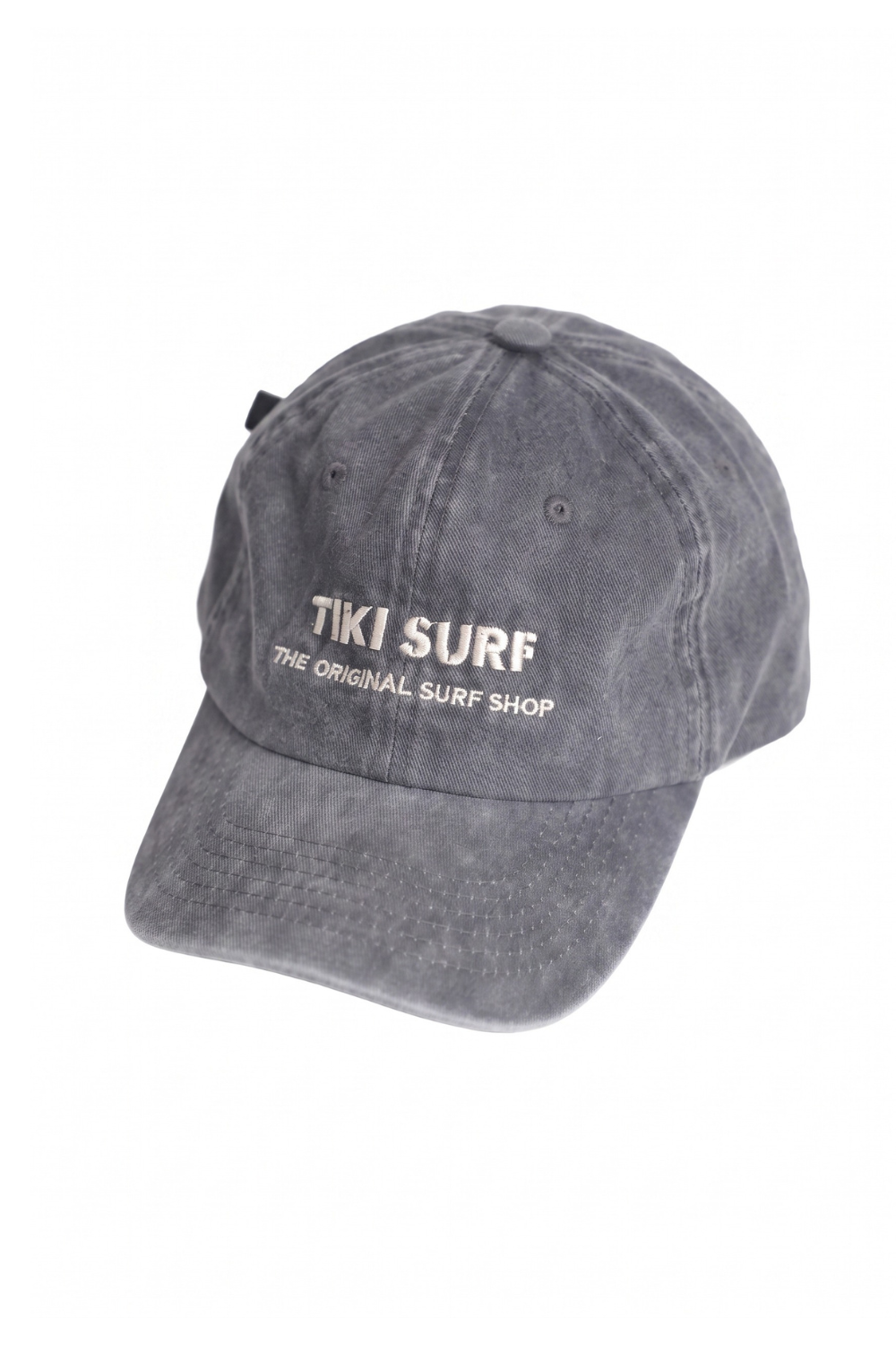 A washed dark gray baseball cap with white embroidered text reading 'TIKI SURF THE ORIGINAL SURF SHOP' on the front, shown against a plain white background.