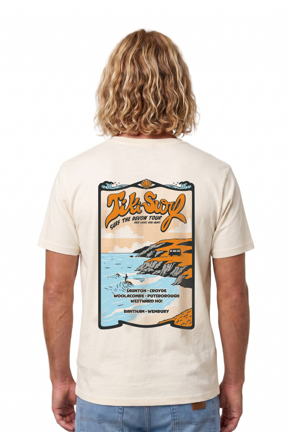 Man wearing a Tiki T-Shirt in vintage white. Featuring a bold retro back print showcasing Devon’s famous surf beaches.