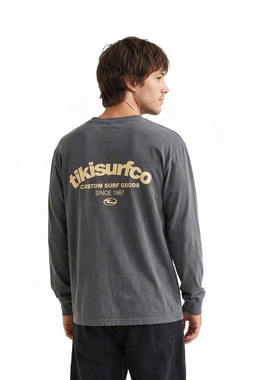 A person wearing a dark grey long sleeved t-shirt with a light yellow 'tikisurfco'printed in the back