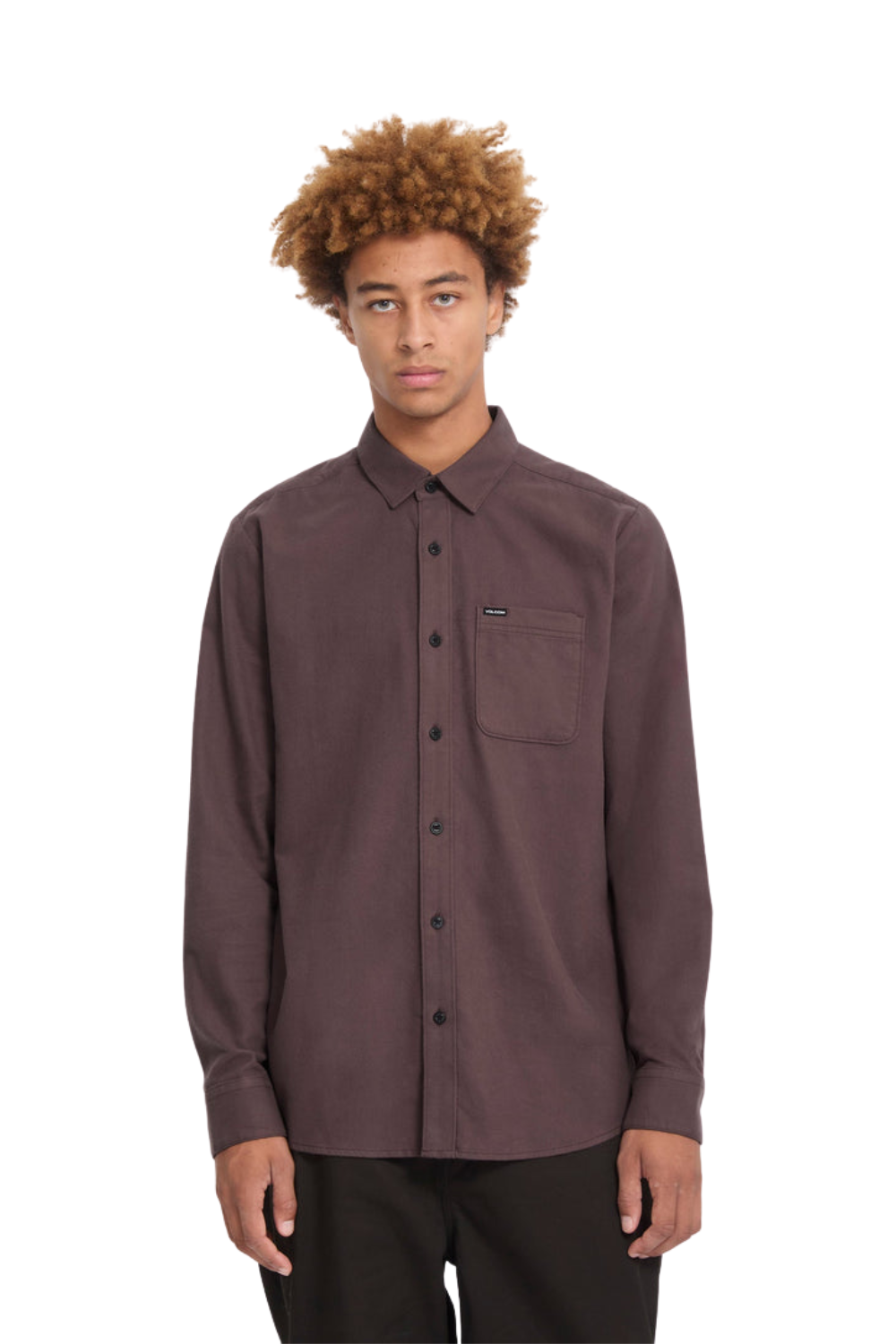 A man with curly brown hair wearing a dark brown long-sleeve button-up shirt with a chest pocket, photographed against a plain white background.