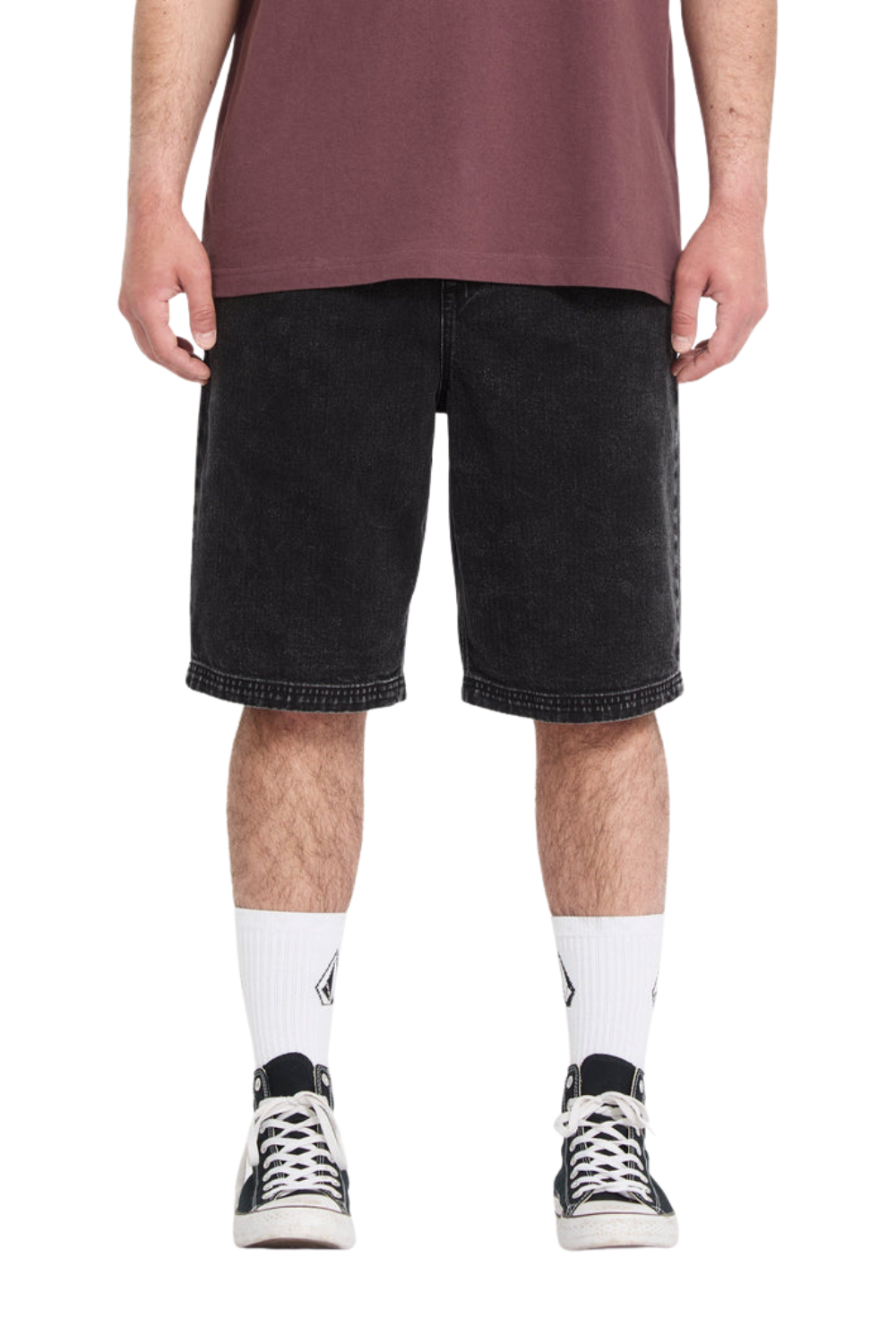 Person wearing black denim shorts