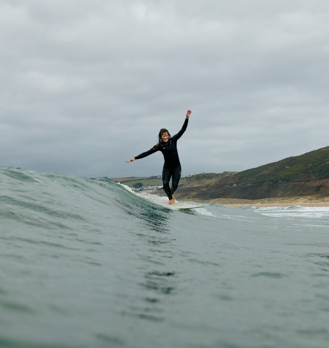 Surfer wearing wetsuit doing a turn on a wave