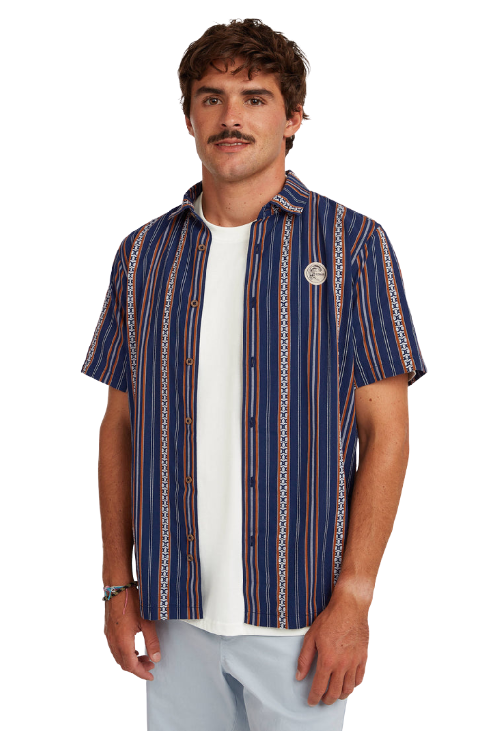 Man wearing a blue patterned shirt over a white t-shirt on a white background