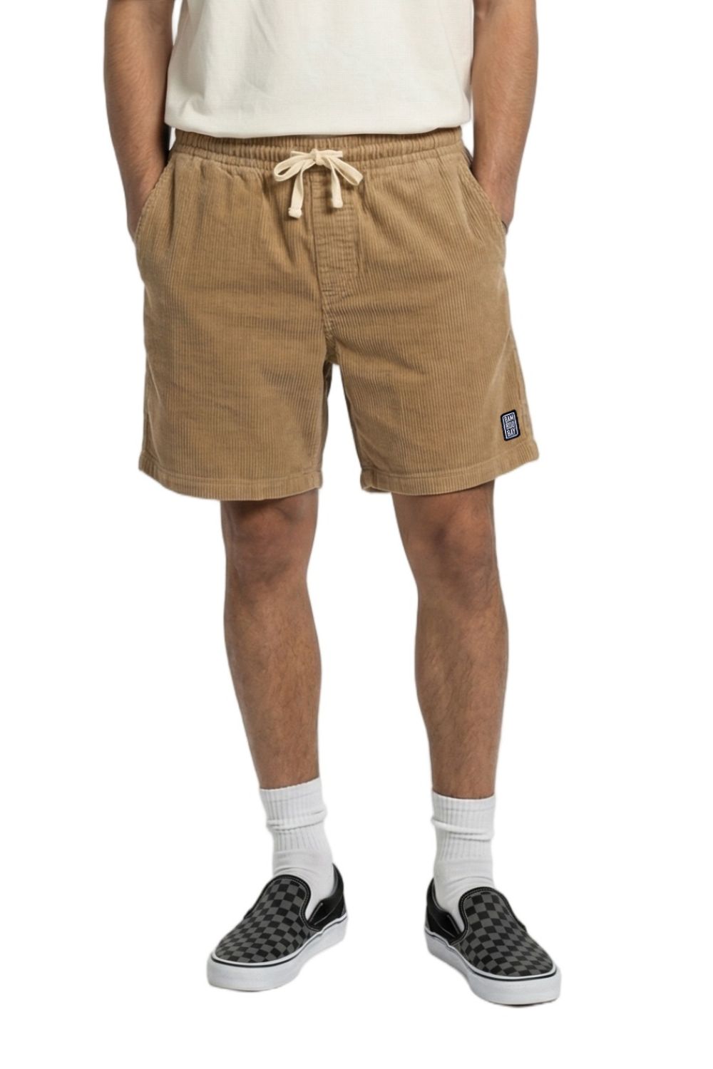 Person wearing tan shorts with a drawstring on a white background