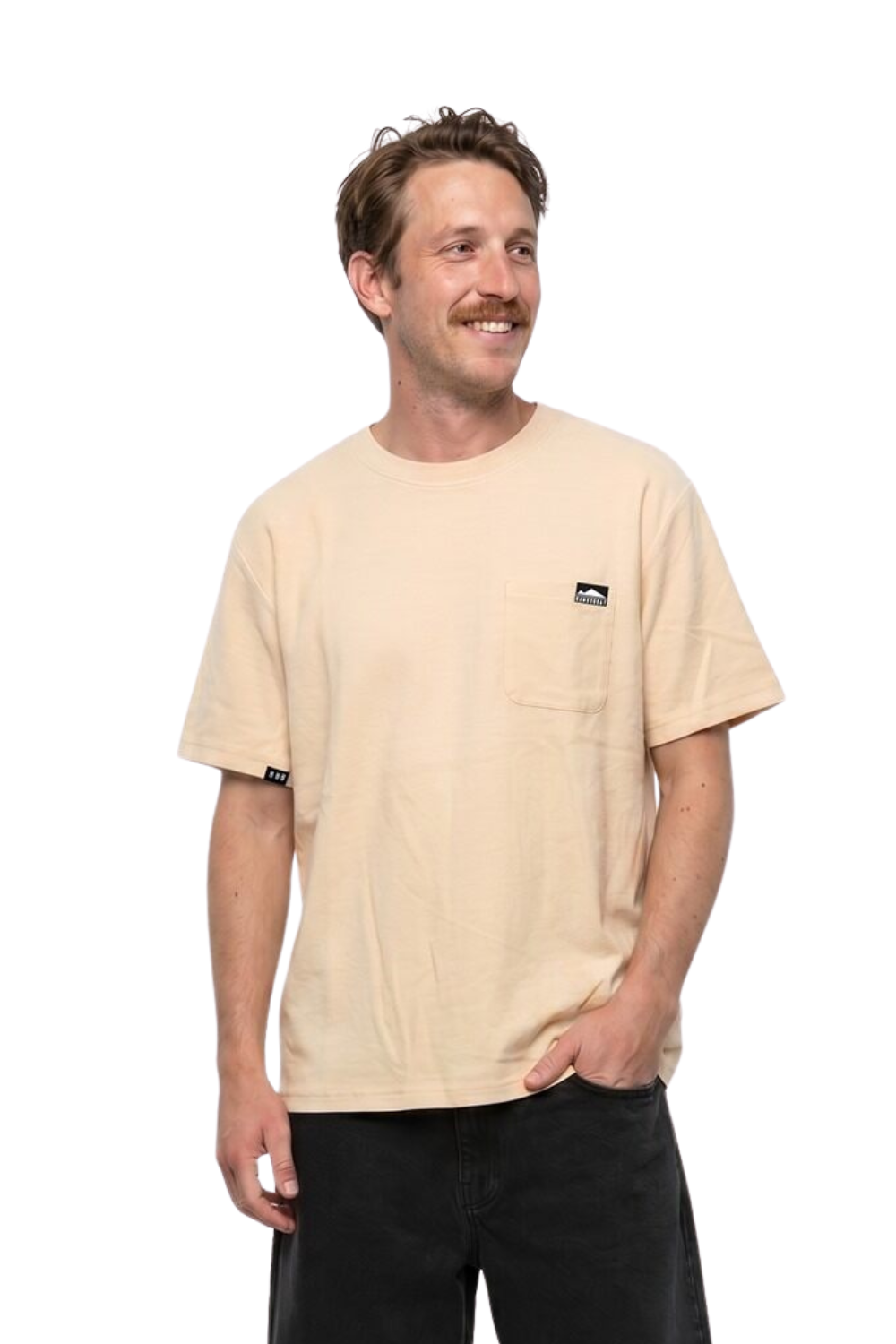 Man wearing a light beige t-shirt with a chest pocket and small logo badge on a white background