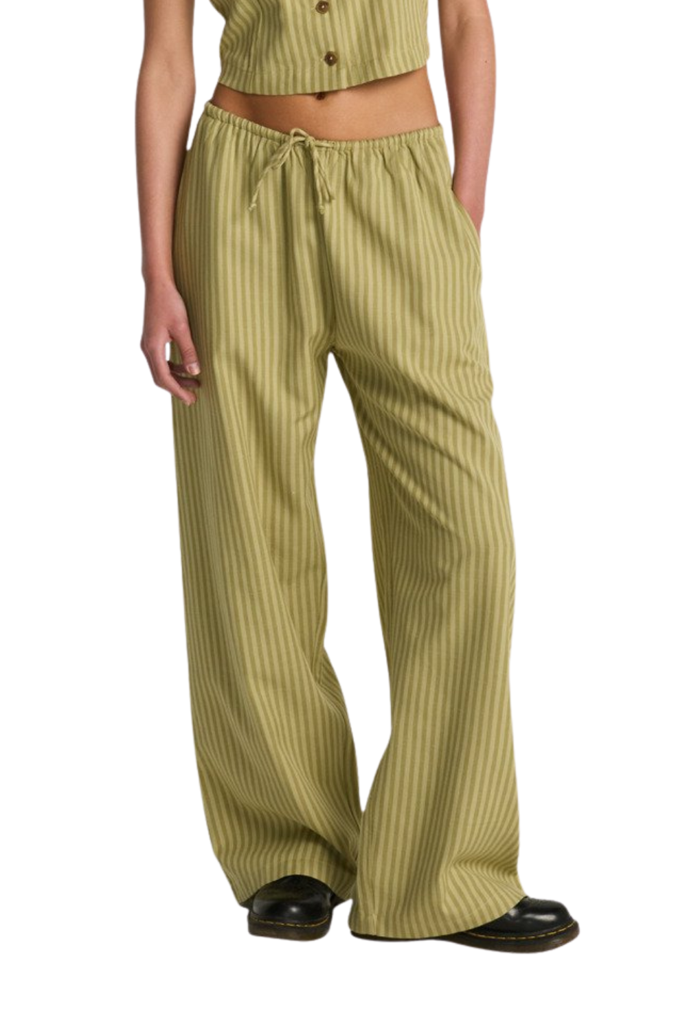 Person wearing green striped pants on a white background