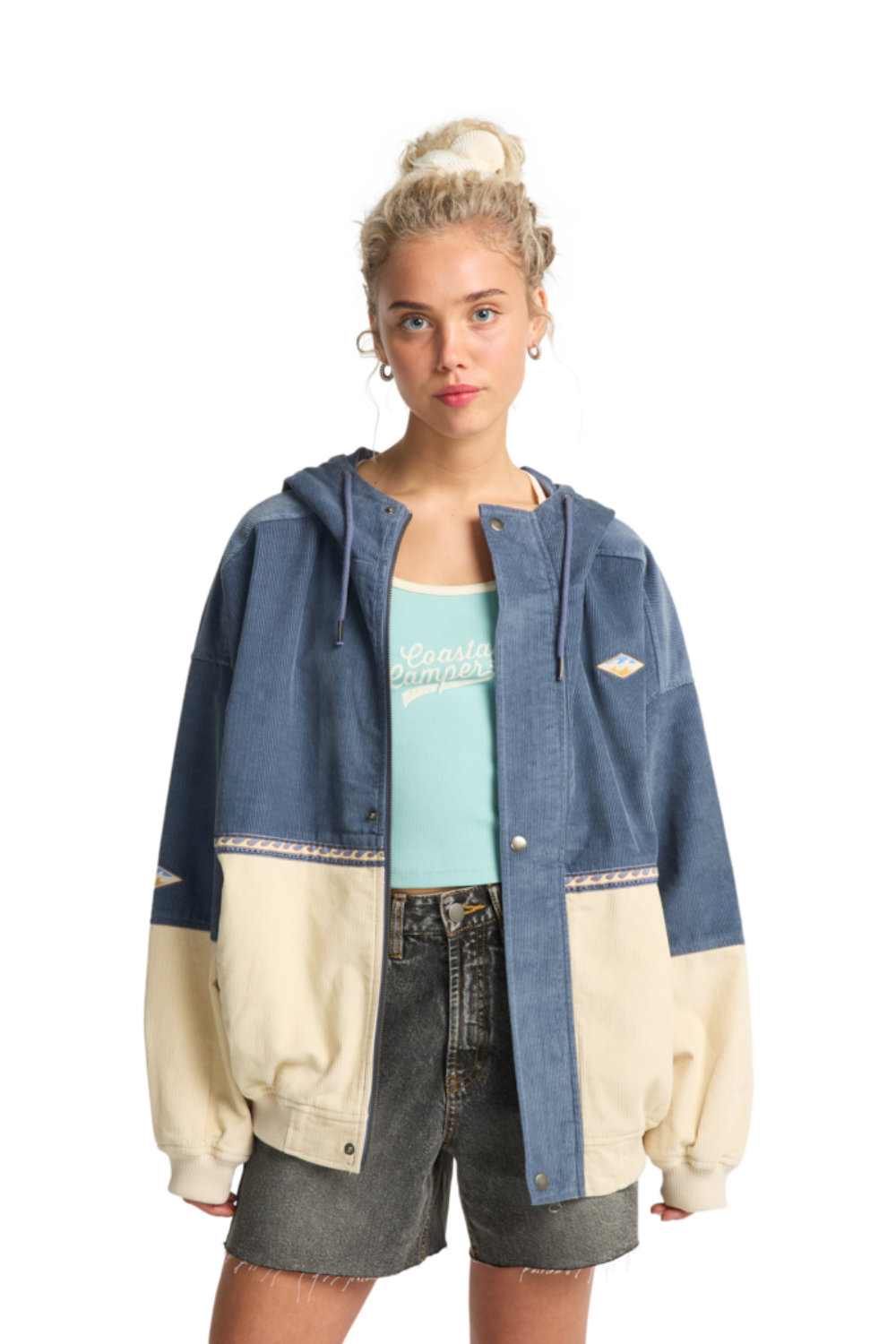 Person wearing a two-tone corduroy jacket with a white background