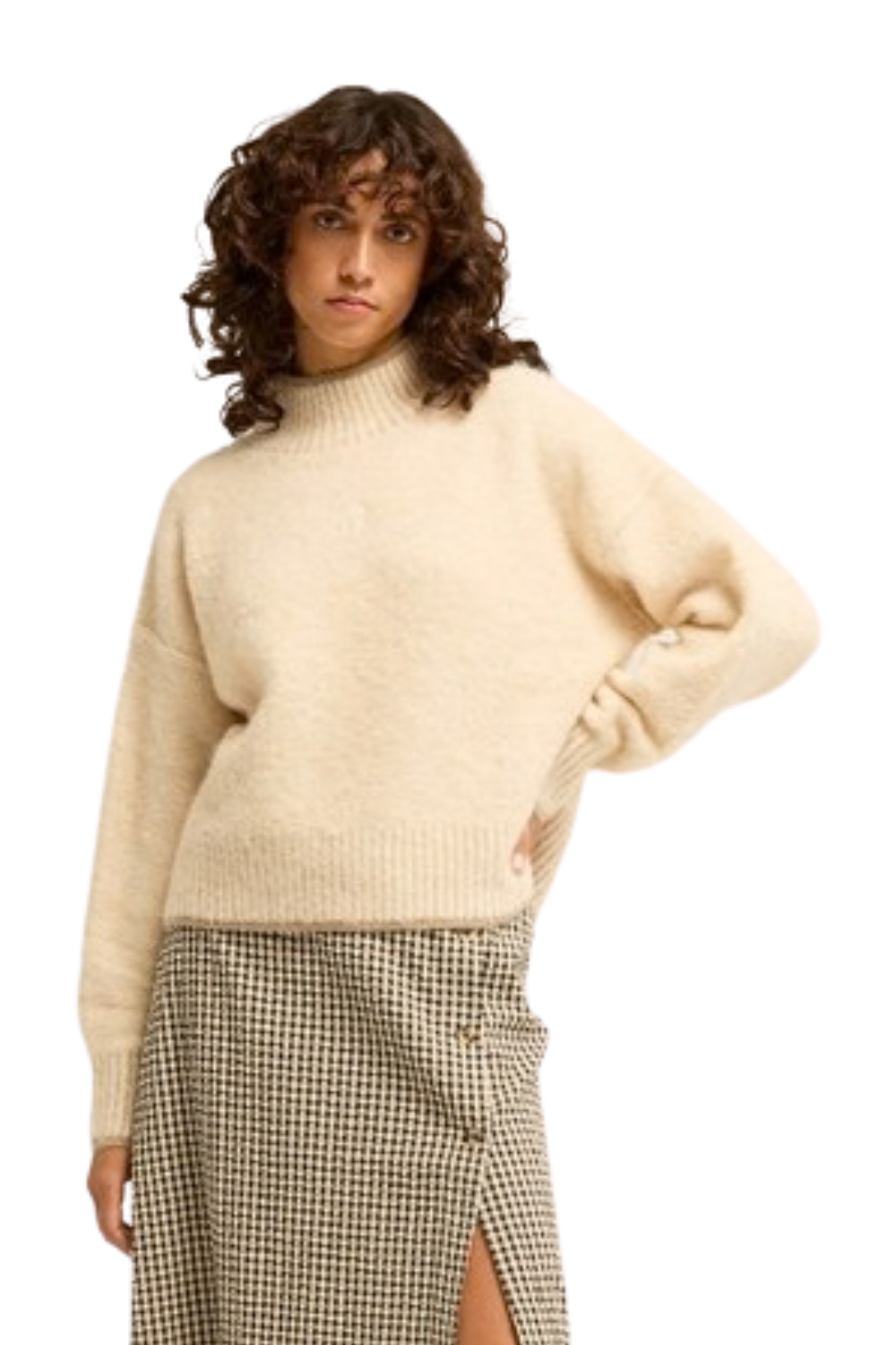 A model wearing a cream-colored, oversized fuzzy knit mock-neck sweater paired with a beige and black houndstooth skirt, set against a plain white background.