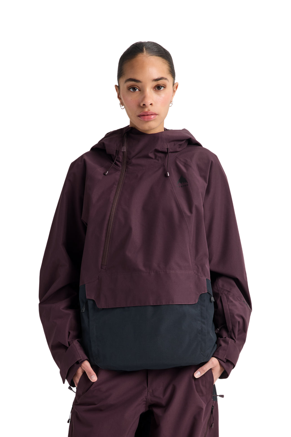 A model wearing a dark plum hooded jacket with a dark navy color-blocked waist panel and matching plum pants, shot against a solid white background.