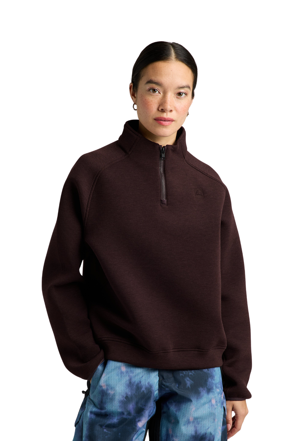 A model wearing a dark brown Burton quarter-zip pullover fleece sweater and blue patterned pants, photographed against a solid white background.