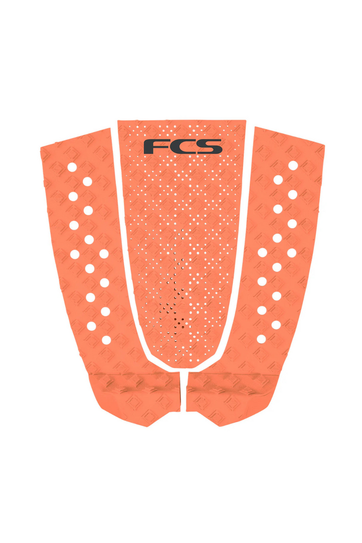 Orange FCS surfboard tail pad on a white background