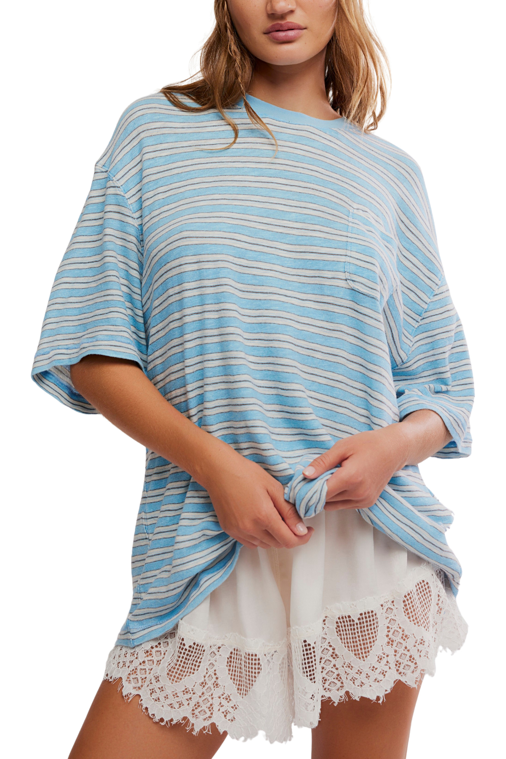 Woman wearing a blue and white striped top with lace shorts on a white background