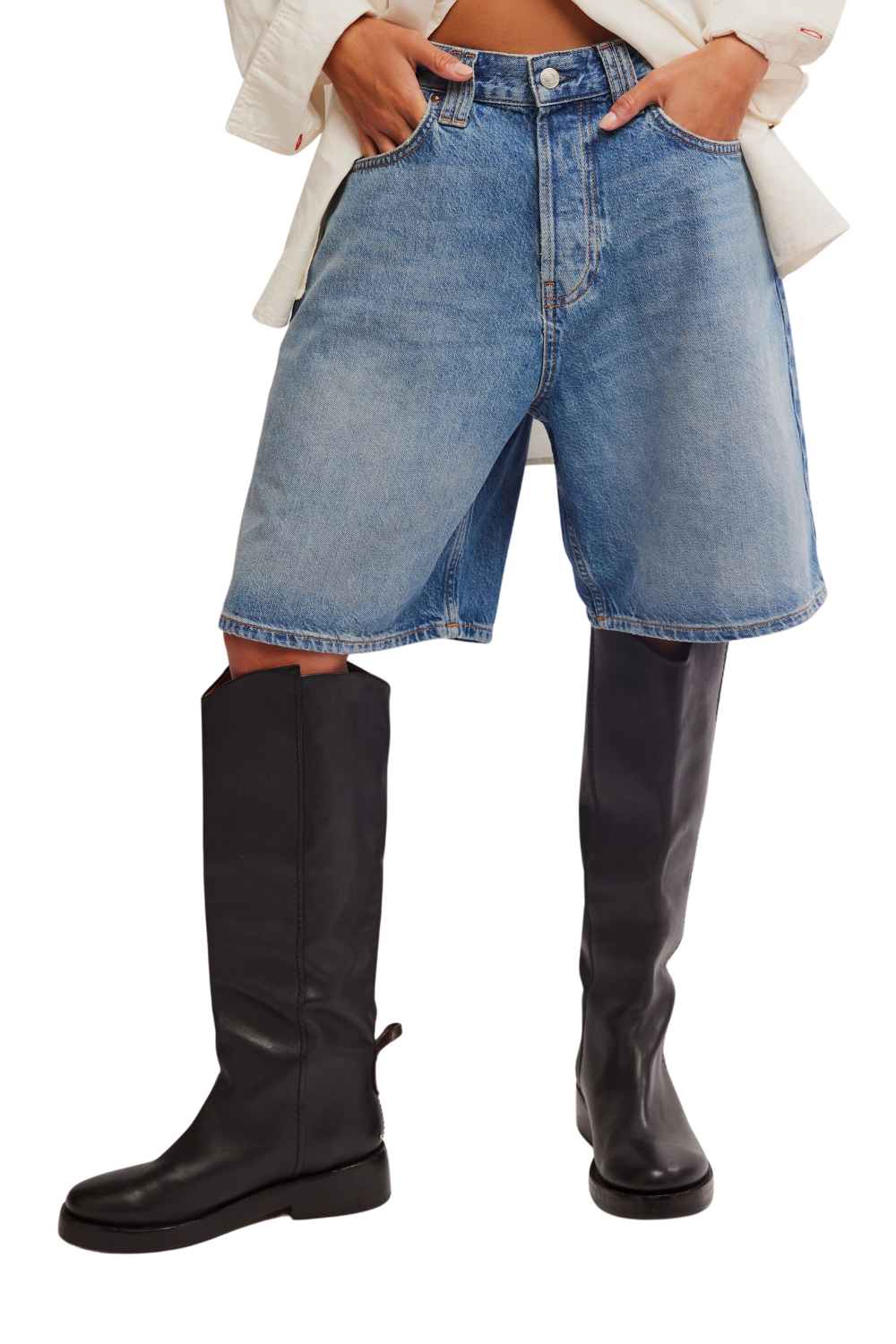 Person wearing blue denim shorts and black knee-high boots on a white background