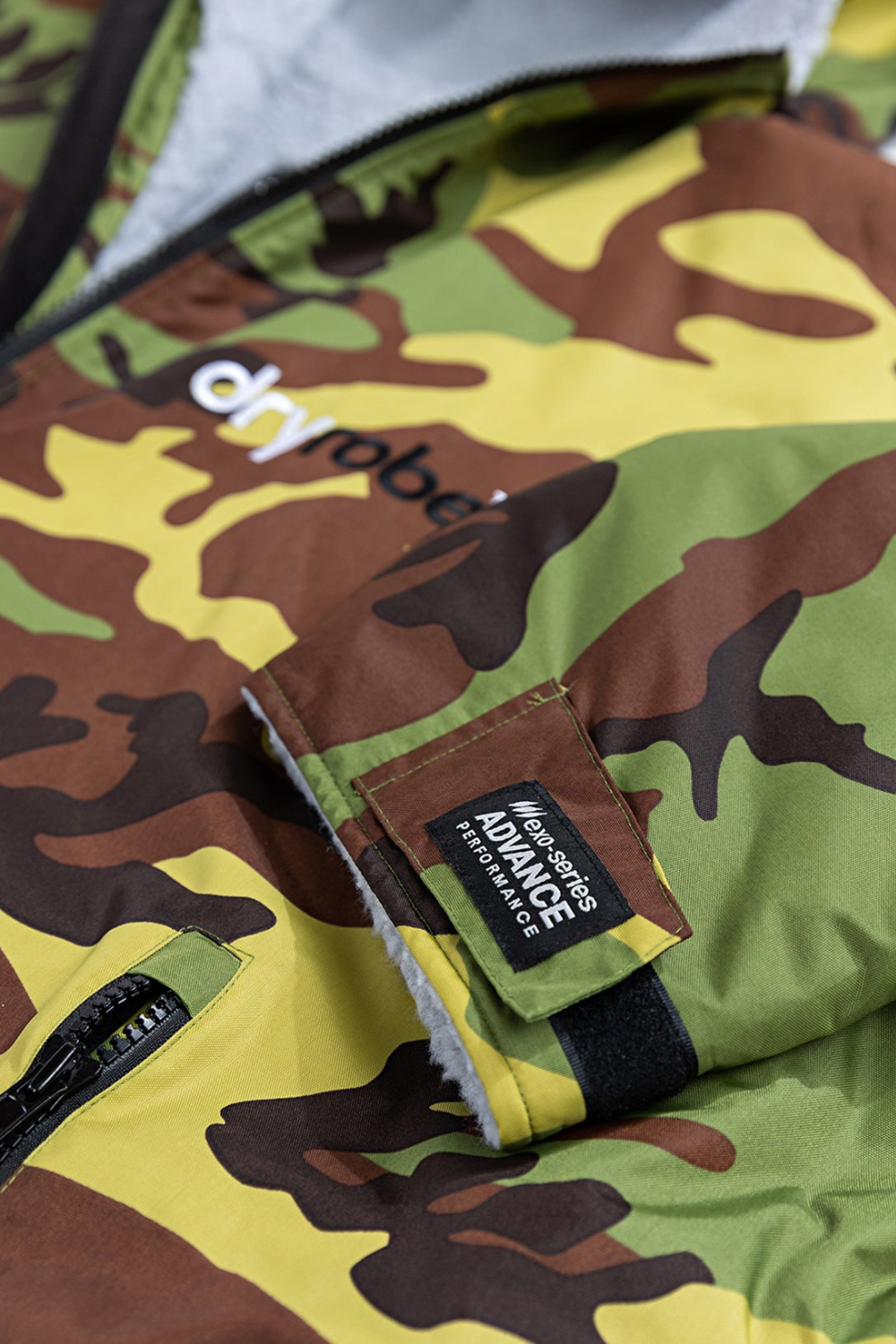 Camouflage jacket with a brand logo and tag on a green background