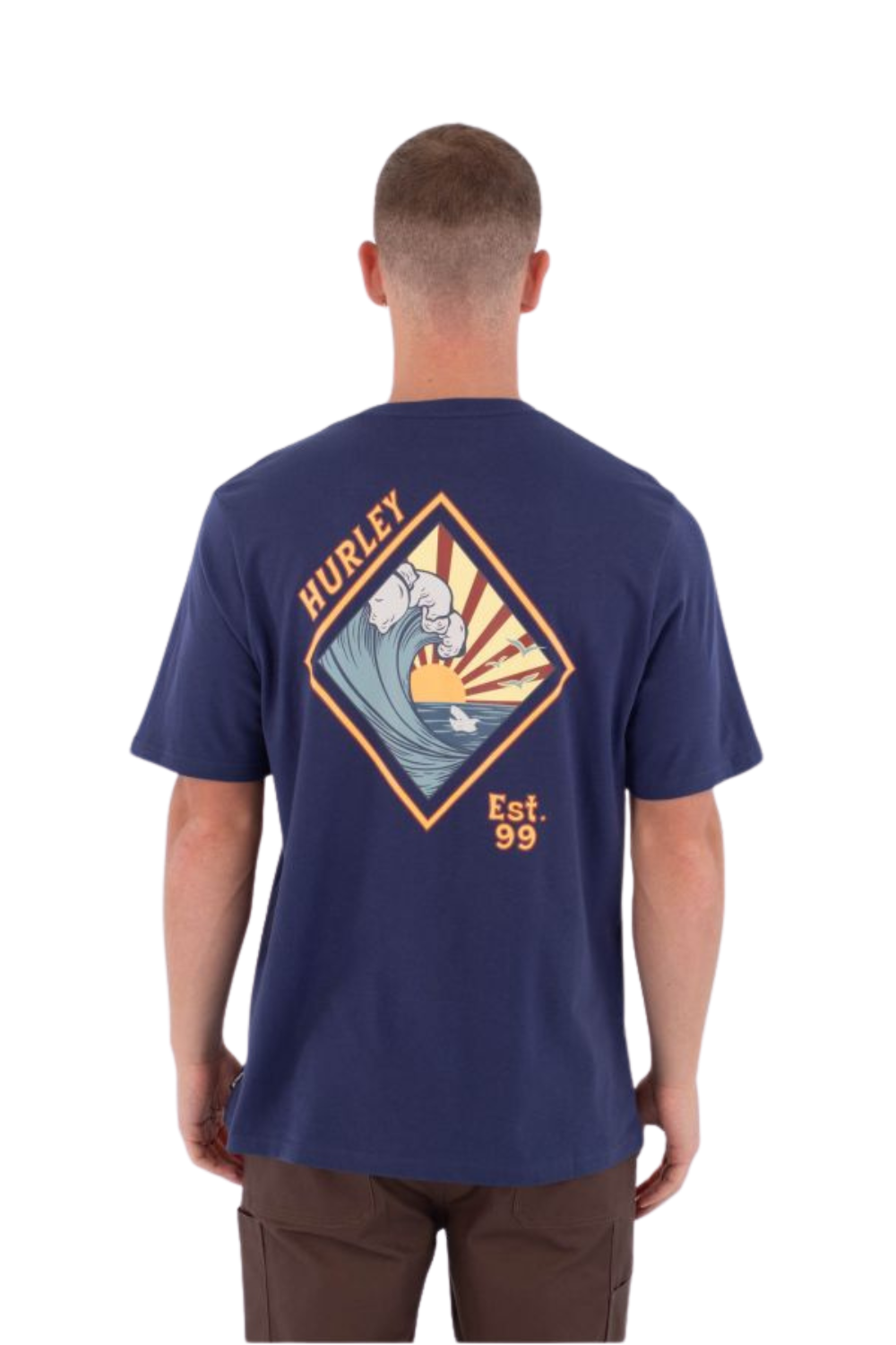 Man wearing a navy blue t-shirt with a graphic design on the back, standing against a white background.