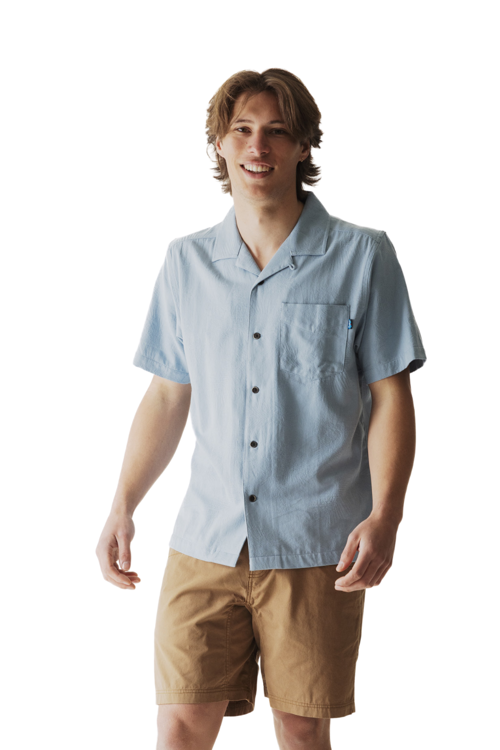 Man wearing a light blue button-up shirt and beige shorts on a white background