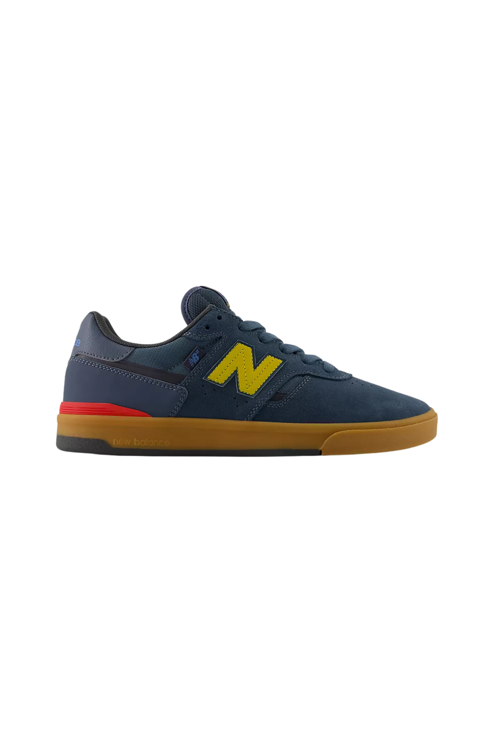 A navy New Balance sneaker with yellow and red detail and rubber sole shown on a white background